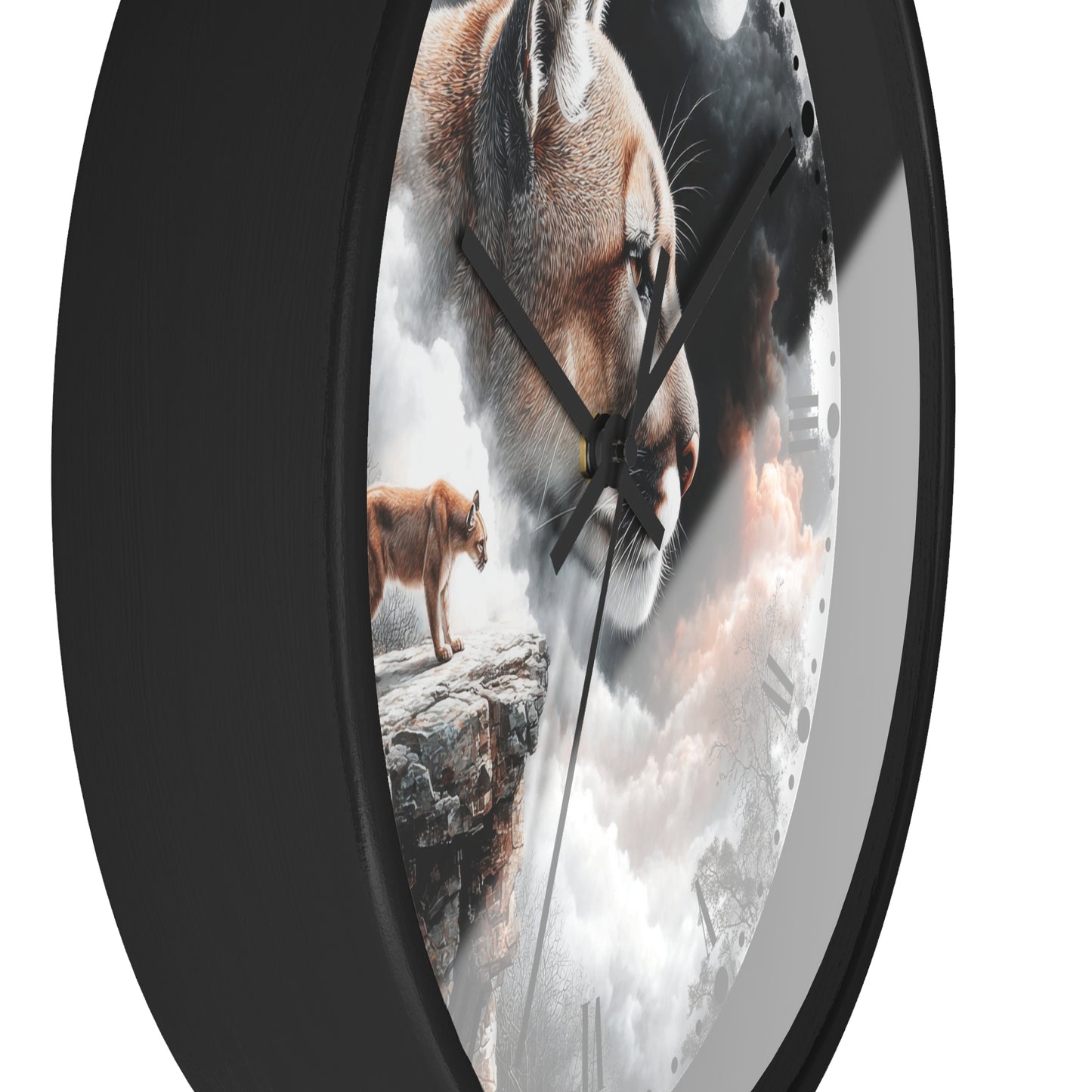 A round wall clock with a black frame and a printed face featuring a large lion face, a smaller lion standing on a rock, and cloudy imagery. The clock is shown at an angle against a plain white background.