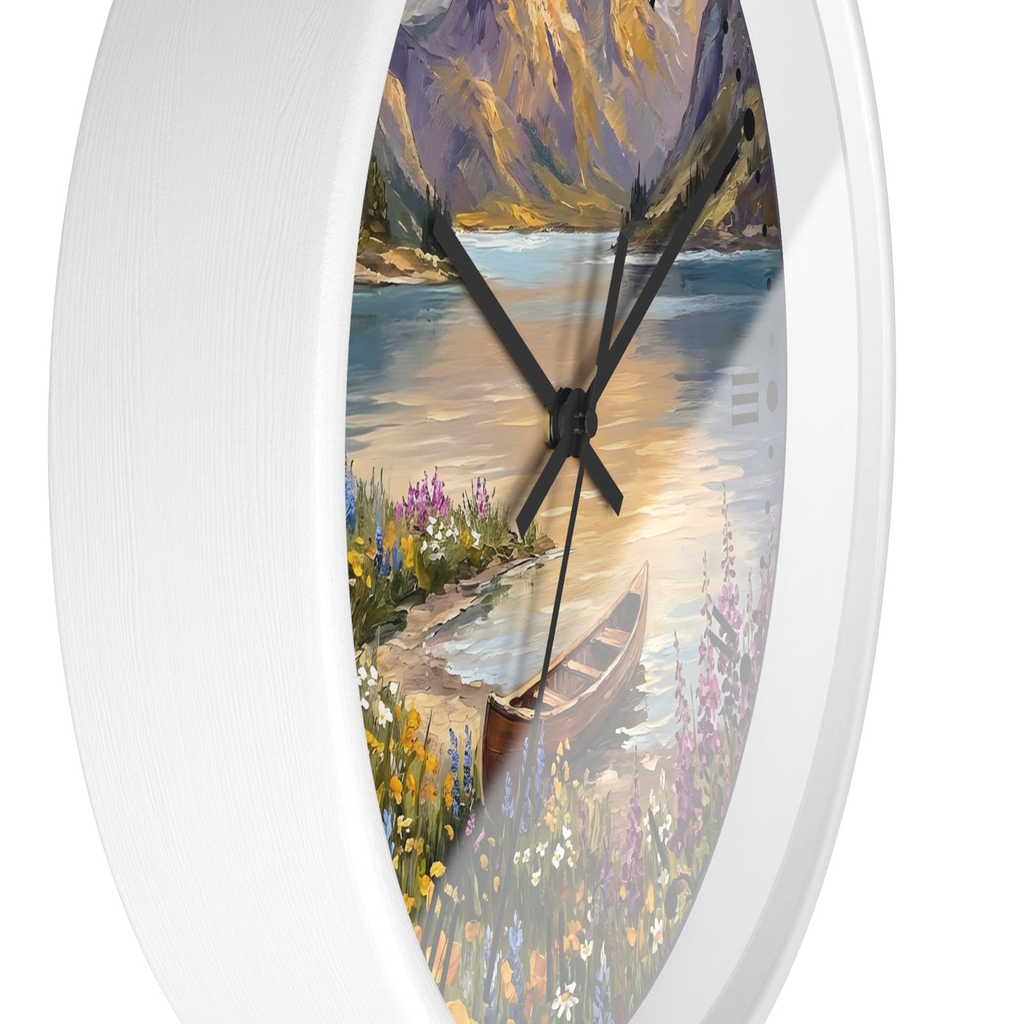 A white oval wall clock featuring a scenic landscape print of a lake, mountains, flowers, and a canoe on the face, with black hands.