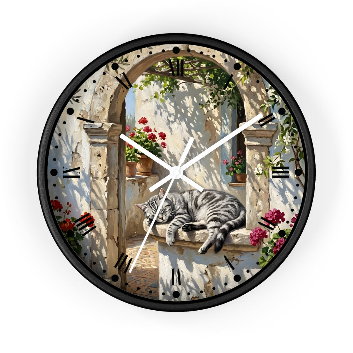A round wall clock with a black frame and white hands, featuring a printed design of a gray tabby cat resting on a stone ledge in an outdoor archway scene with flowers and greenery.