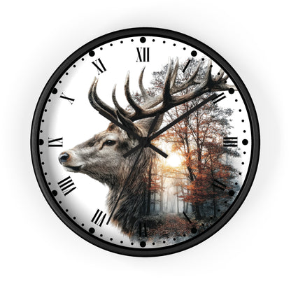 A round wall clock with a black frame and Roman numerals, featuring a printed design of a large deer head over a misty forest scene with autumn trees.