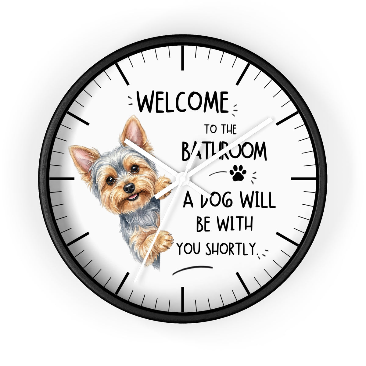 A round wall clock with a black frame and white face, featuring a small dog illustration and the text 'WELCOME TO THE BATHROOM A DOG WILL BE WITH YOU SHORTLY.' on a light gray background.