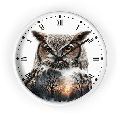 A round wall clock with a white face, black Roman numerals, and a large owl printed across the front. The owl's feathers blend into a forest sunset scene near the bottom.
