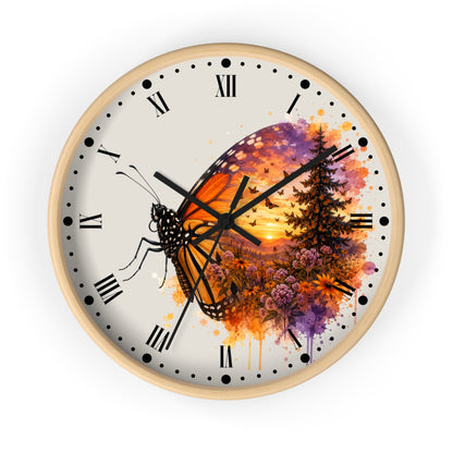 A round wall clock with a light wood frame and a cream-colored face, featuring a colorful butterfly and forest sunset illustration. The clock has black Roman numerals and black hands, shown against a plain white background.