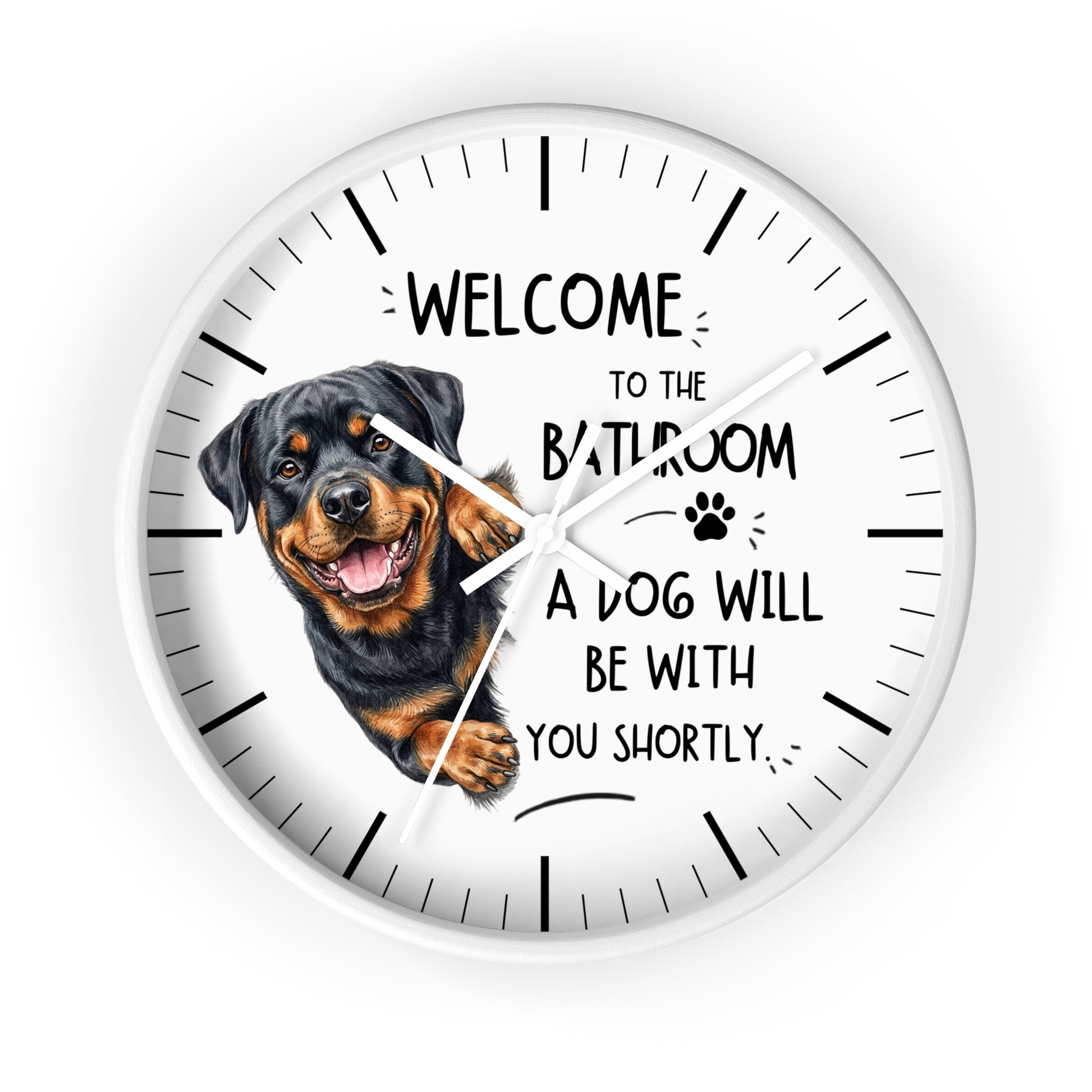 A round white wall clock featuring a Rottweiler dog illustration and the humorous text 'WELCOME TO THE BATHROOM A DOG WILL BE WITH YOU SHORTLY.' The clock has black hour markers and white hands on a clean white background.
