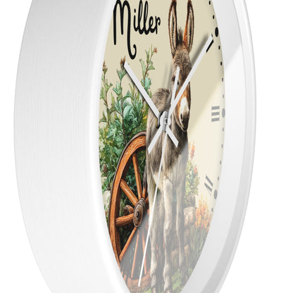 A round white wall clock with a custom printed face featuring a donkey, a wagon wheel, and the name 'Miller' in black script at the top.