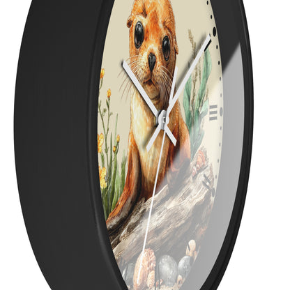 A close-up of a round wall clock with a black frame and a printed illustration of a seal or sea lion on the face, with white hands and minimal black hour markers.