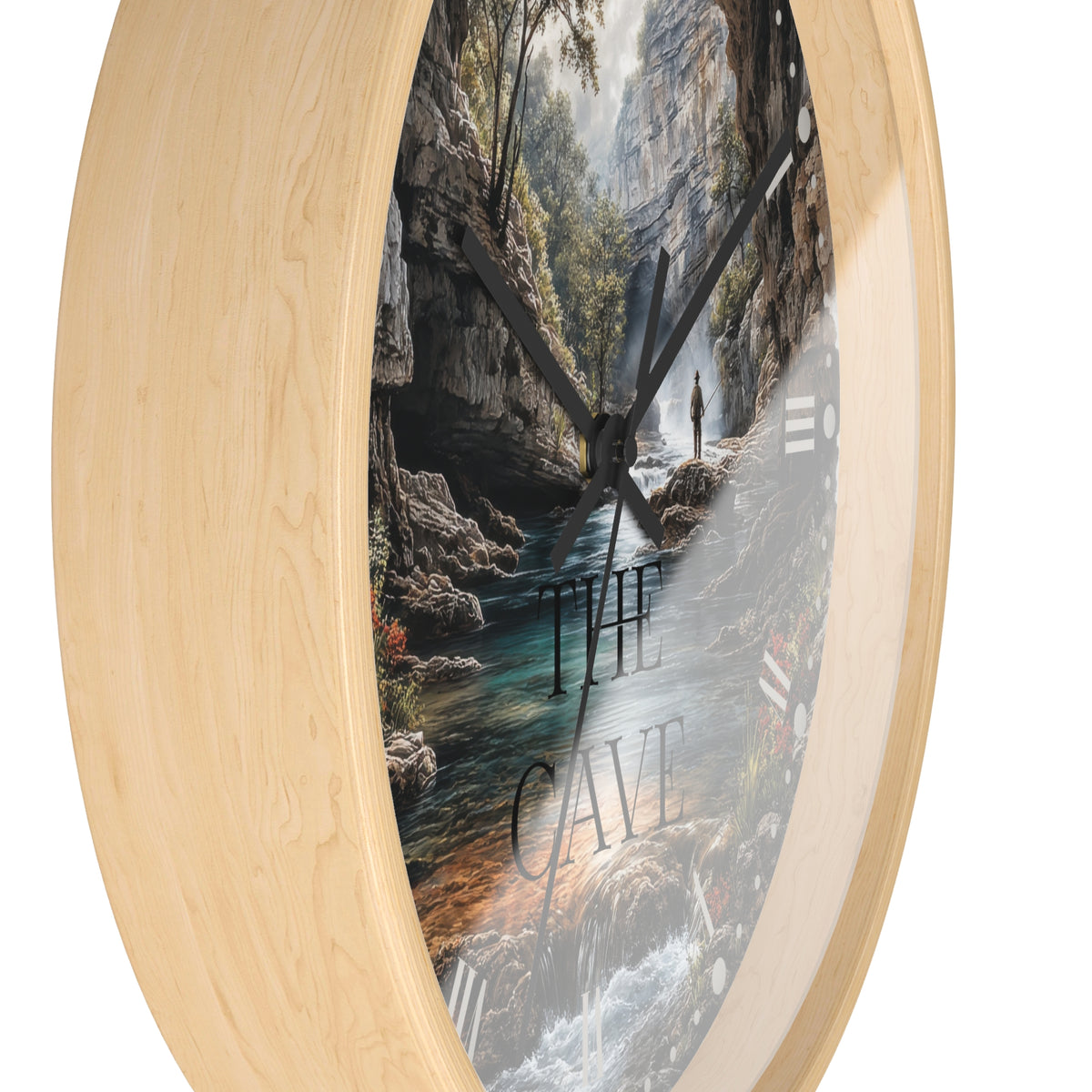 Round wall clock with a light natural wood frame and a printed scenic dial showing a cave interior with water, rocks, and the words “THE CAVE,” photographed on a white background.