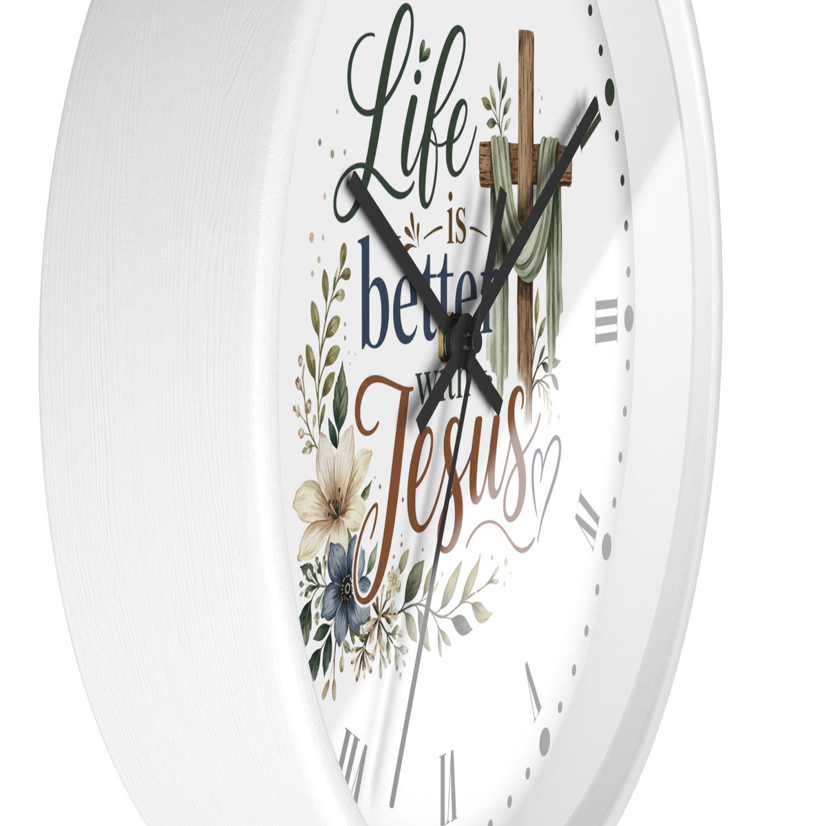 White round wall clock with a Christian-themed design featuring the text 'Life is better with Jesus' in decorative script and serif fonts, surrounded by floral and leaf illustrations, with a wooden cross graphic at the top.