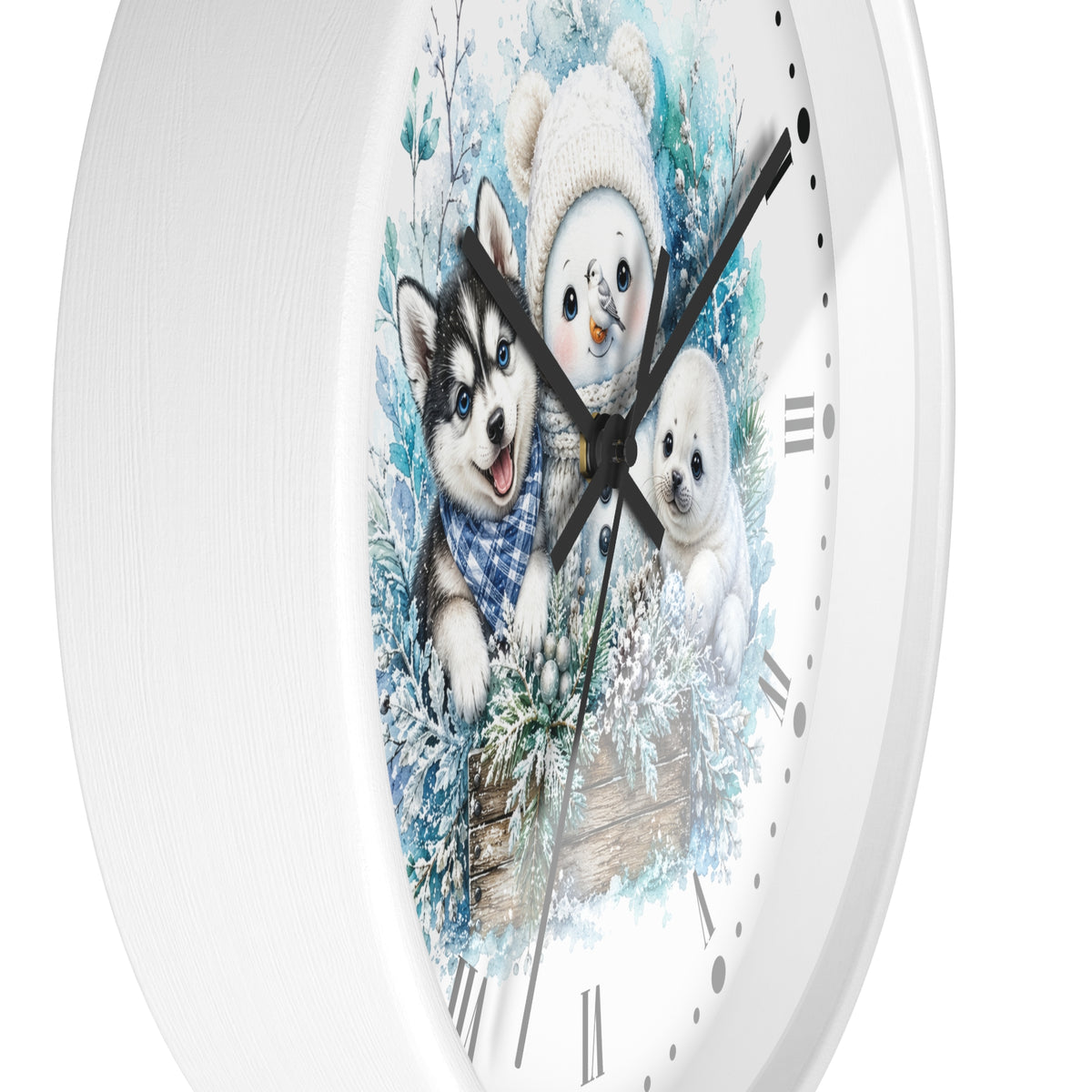 A round white wall clock with a winter illustration of three puppies on the face, including a husky puppy in a blue plaid sweater, a white puppy, and a snowman wearing a cream knit hat. The clock has black hands and Roman numerals on a clean white background.