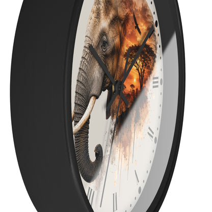 A round wall clock with a black frame and a white face featuring a printed elephant and sunset scene, photographed against a plain white background.