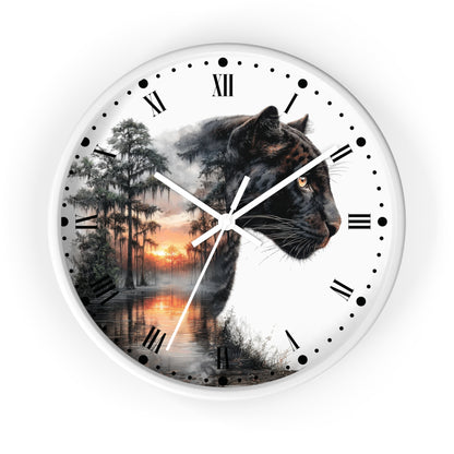 A round wall clock with a white frame and a split design: one half shows a black panther in profile, and the other half shows a misty forest lake sunset. Roman numerals and black dot hour markers are printed on a white face, with white clock hands.
