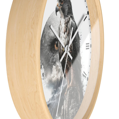 Round wall clock with a light natural wood frame and a printed face featuring a large hawk head in grayscale and brown tones over a smoky mountain background.