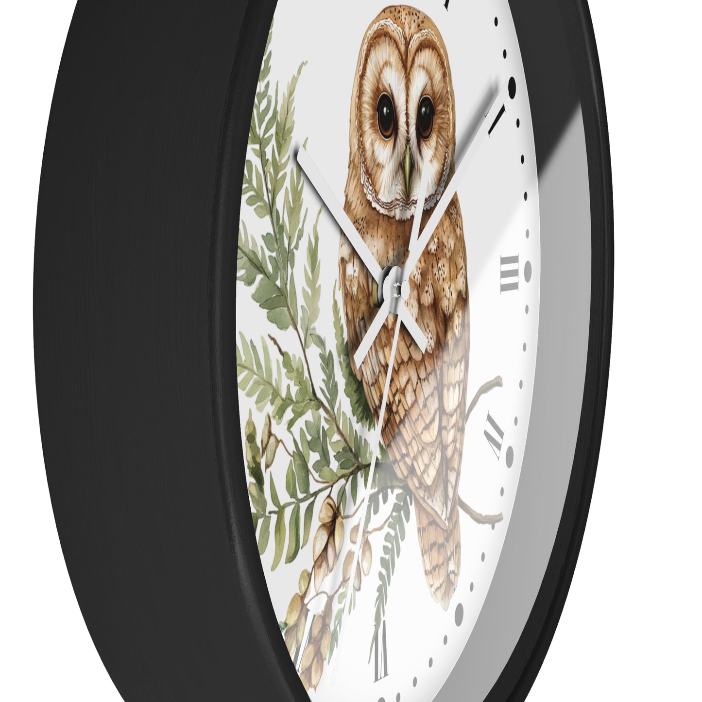 A close-up of a round wall clock with a black frame and a white dial featuring a detailed illustration of a brown owl perched among green leaves.