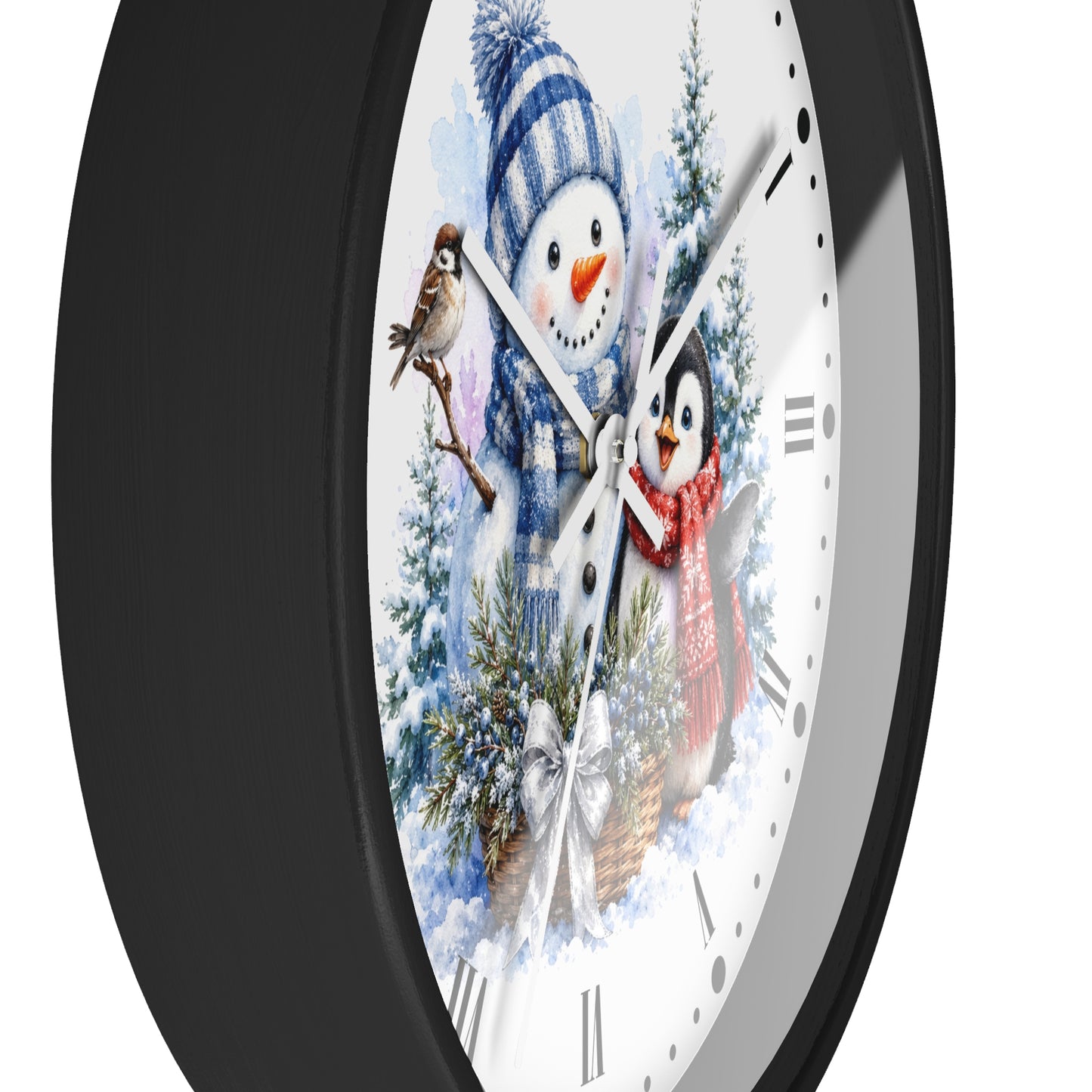 A round wall clock with a black frame and a white face featuring a winter illustration of a snowman, a penguin, birds, evergreen trees, and a basket of ornaments.