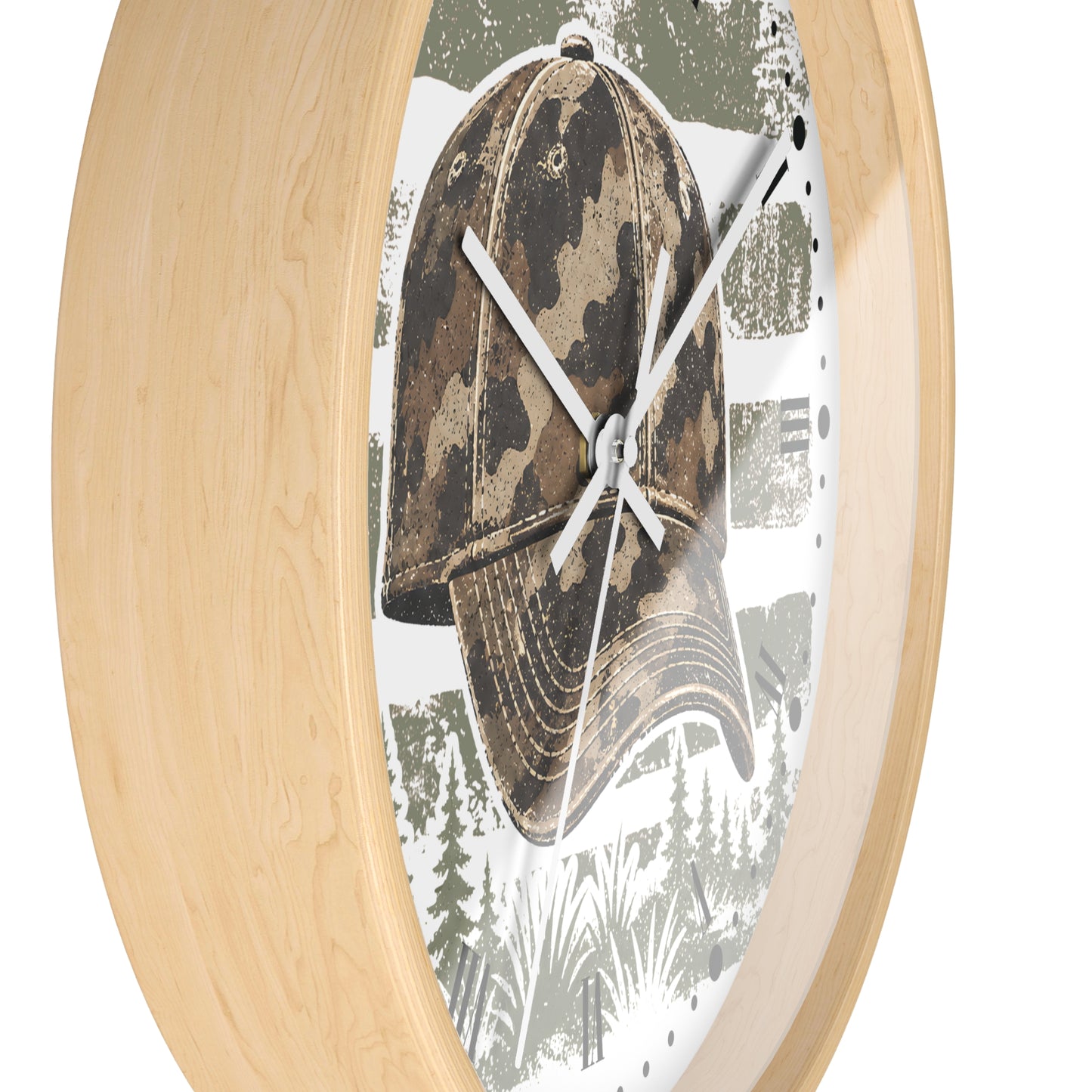 Oval wall clock with a light natural wood frame and a printed face featuring a camouflage baseball cap over a forest scene.