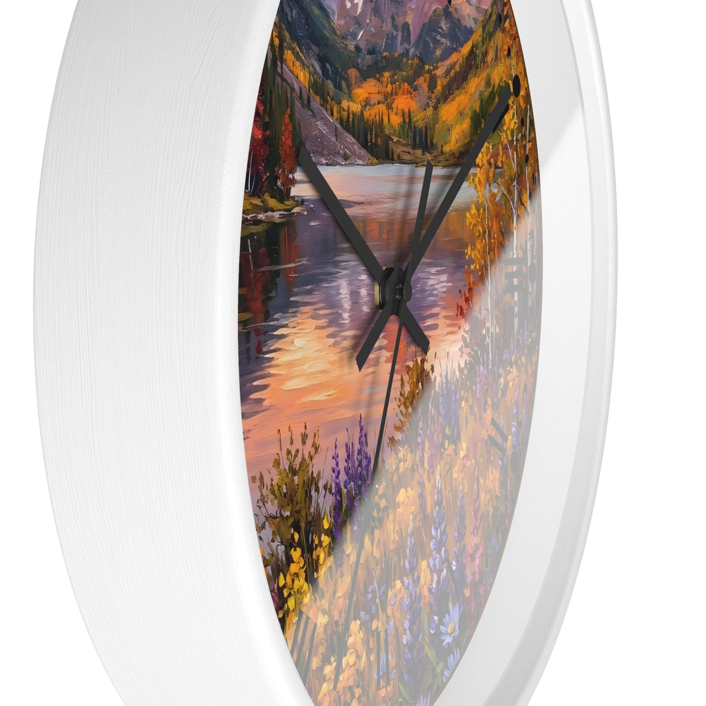 A white oval wall clock with a colorful landscape print on the face, showing autumn trees, mountains, and a reflective river, with black hands.