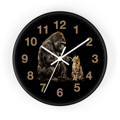 A round wall clock with a black frame and black face, featuring a detailed illustration of a gorilla and a cat in gold and brown tones, with gold Arabic numerals and white hands, shown on a white background.