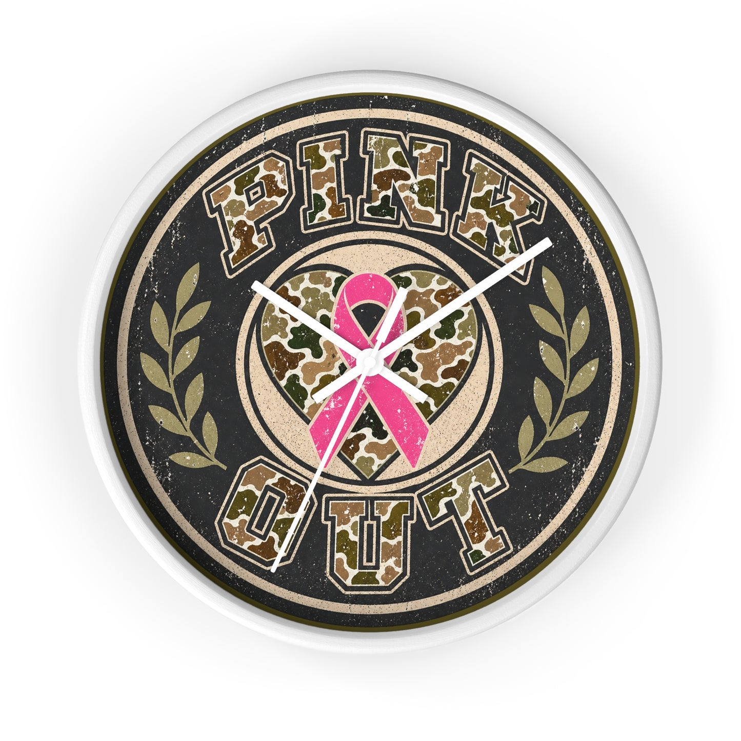 A round wall clock with a distressed design featuring the words 'PINK OUT' in a camouflage pattern, a pink ribbon in the center, and olive branch motifs on either side, all set against a black background with a white clock frame.