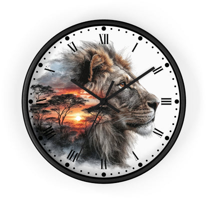 A round wall clock with a black frame and a printed design featuring a lion's face over an African savanna sunset scene. The clock face is white with black Roman numerals and black clock hands.