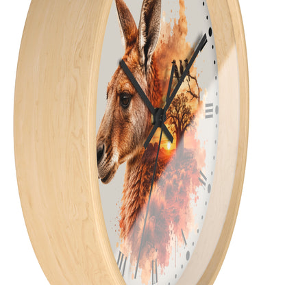 Round wall clock with a light natural wood frame and a printed face featuring a kangaroo profile over an autumn tree silhouette and sunset, with black hands and Roman numerals.