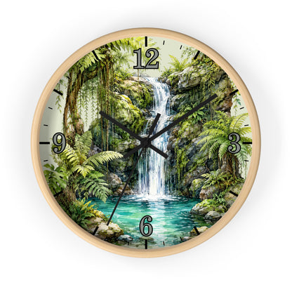 Round wall clock with a light wood frame and a printed tropical jungle scene featuring a waterfall, green foliage, and turquoise water. Black Arabic numerals mark the hours, and the clock hands are black.