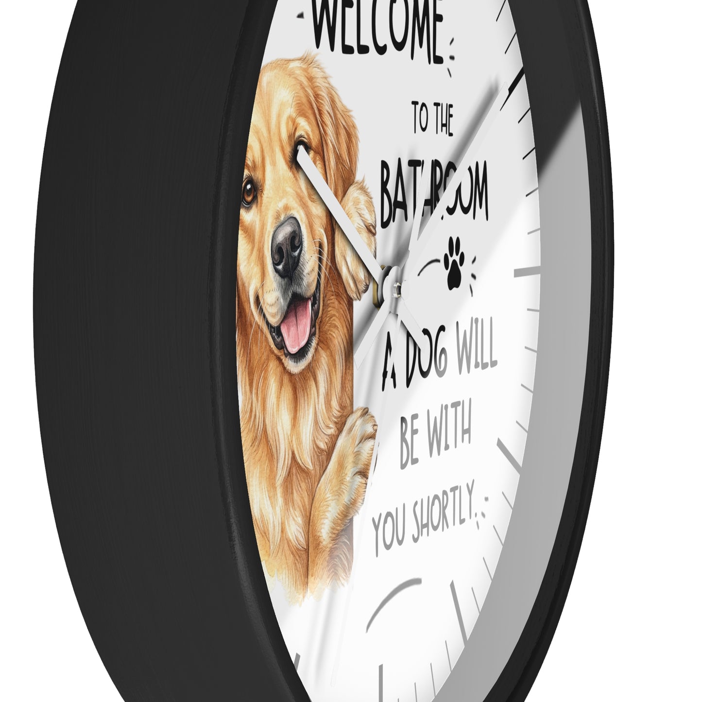 A round wall clock with a black frame and a white face featuring a golden retriever illustration and the text 'WELCOME TO THE BATROOM A DOG WILL BE WITH YOU SHORTLY'.