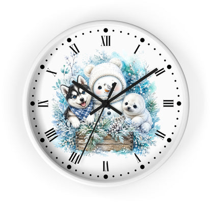 A round wall clock with a white face and black Roman numerals, featuring a winter illustration of a snowman, a husky, and a polar bear surrounded by blue foliage and pine branches.
