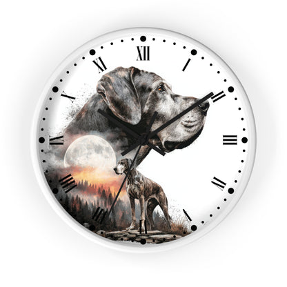 A round wall clock with a white face and black Roman numerals, featuring a printed design of two gray dogs over a moonlit forest scene with a sunset.