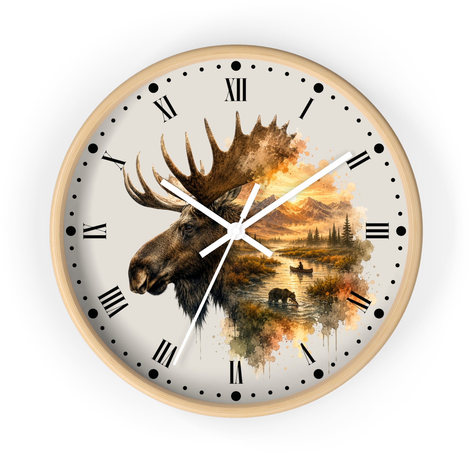 A round wall clock with a light wood frame, featuring a cream-colored face printed with a moose head and a scenic autumn landscape in warm brown, orange, and yellow tones. The clock has black Roman numerals, black dot hour markers, and white hands.
