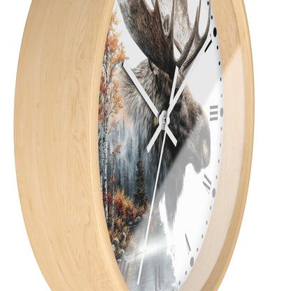 Oval wall clock with a light natural wood frame and a split-face design showing a moose head on one side and a forest scene on the other, with white hands and black Roman numerals.
