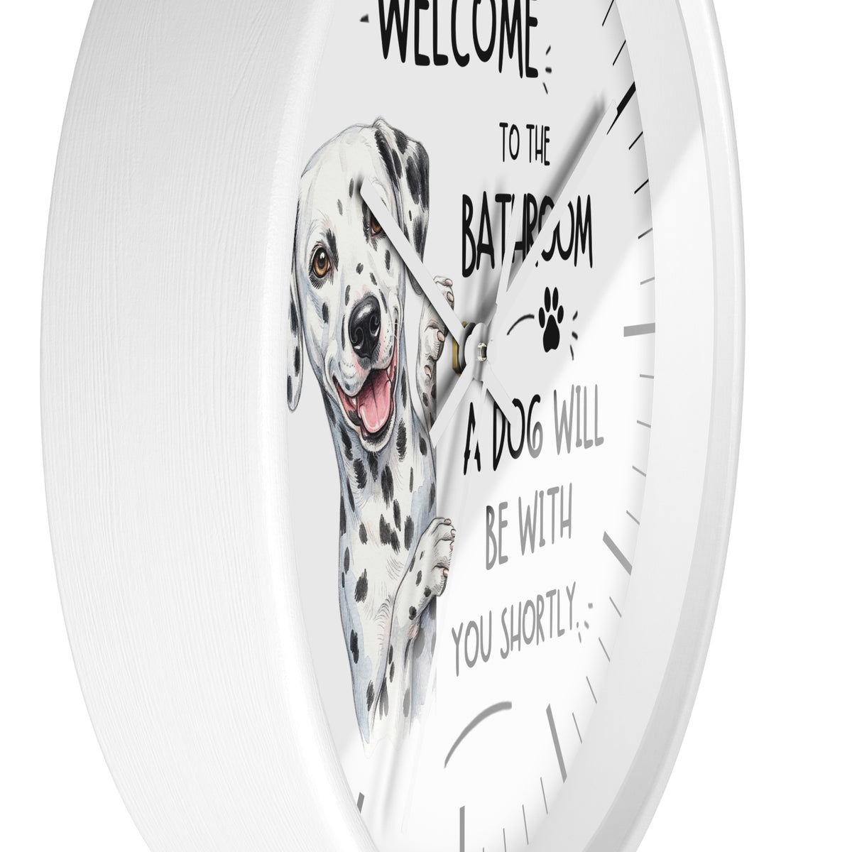 A white round wall clock with a printed illustration of a Dalmatian dog and the humorous text 'WELCOME TO THE BATROOM A DOG WILL BE WITH YOU SHORTLY' on a clean white background.