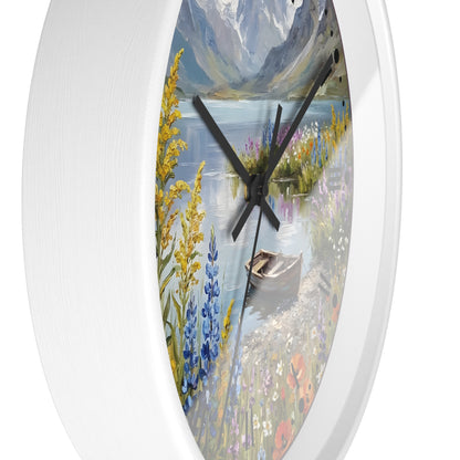 Round wall clock with a white frame and a scenic landscape print featuring a lake, mountains, wildflowers, and a small boat, shown against a white background.