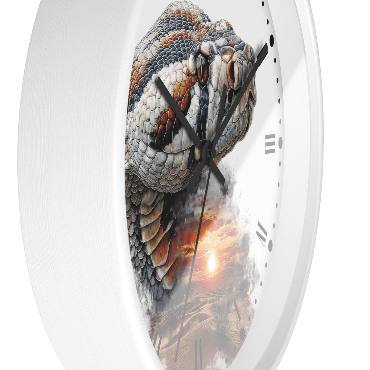 A white oval wall clock featuring a detailed graphic print of a coiled rattlesnake over a desert sunset scene, with black Roman numerals and black hands.
