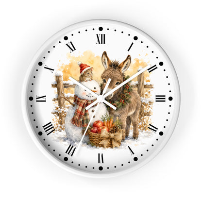 A round white wall clock with black Roman numerals and hour markers, featuring a festive winter illustration of a snowman and a donkey with autumn and Christmas elements on the face.