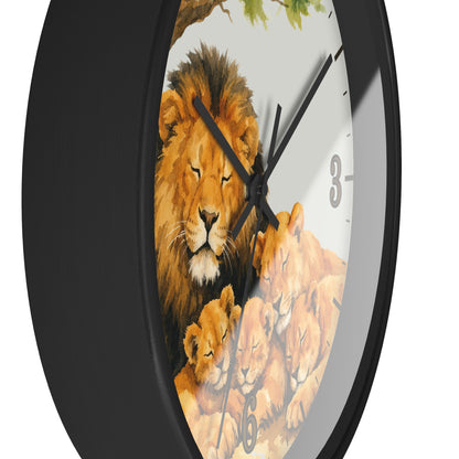 A round wall clock with a black frame and a printed face showing a lion and lion cub illustration, photographed against a plain white background.