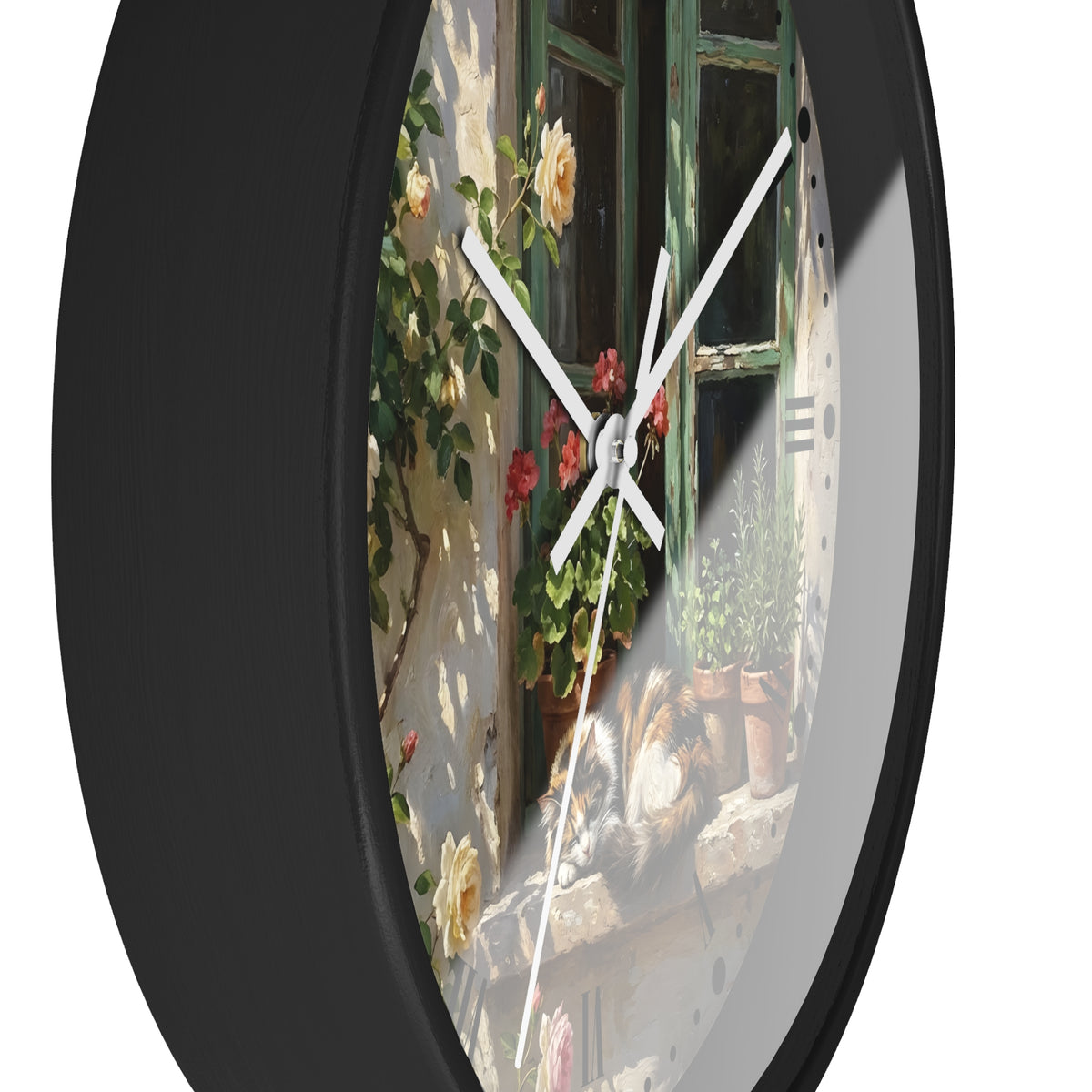 A round wall clock with a black frame and a printed scenic face showing a sunlit stone wall, green window, climbing flowers, and a cat on a windowsill. The clock is photographed against a plain white background.