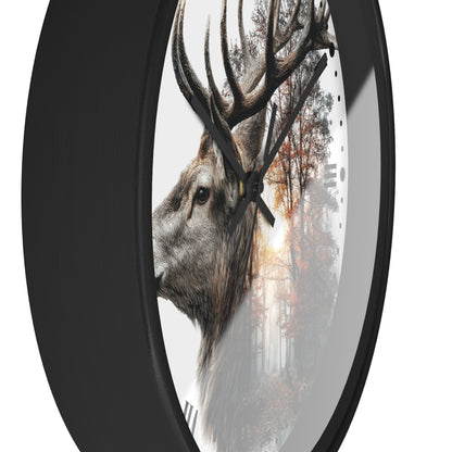 A round wall clock with a black frame and a printed design of a deer head layered over a misty forest scene, shown against a plain white background.