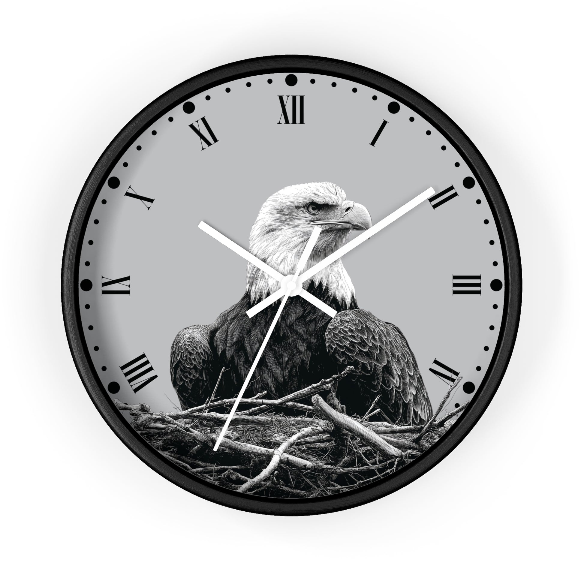 Round wall clock with a black frame and a grayscale bald eagle perched in a nest on the clock face, with Roman numerals and white hands, shown against a light gray background.