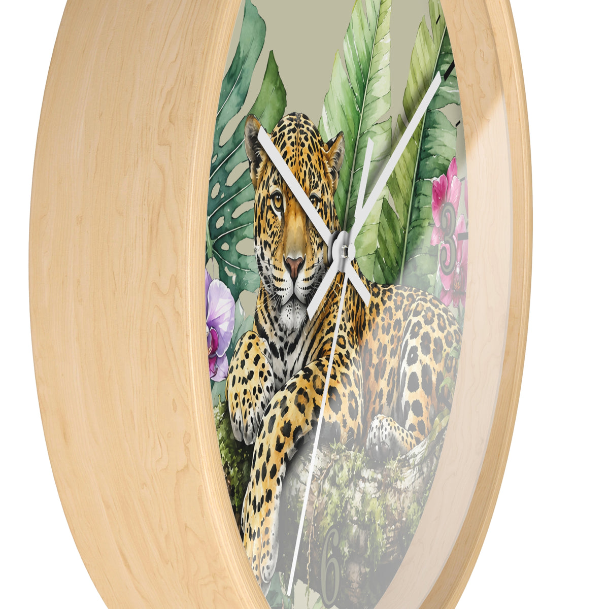 Round wall clock with a light natural wood frame and a tropical print featuring a leopard, palm leaves, and flowers on the clock face, shown against a plain white background.