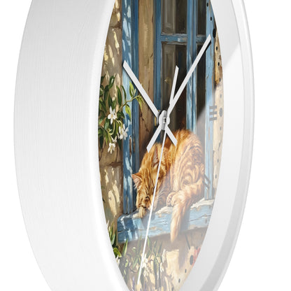Oval white wall clock with a printed illustration of an orange tabby cat resting on a weathered blue window sill.