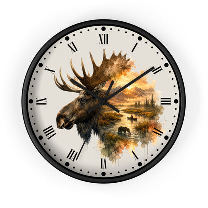 Round wall clock with a black frame and a cream-colored face featuring a moose head illustration and an autumn landscape scene with water, trees, and bears. Roman numerals mark the hours, with black hands and small dot indicators.