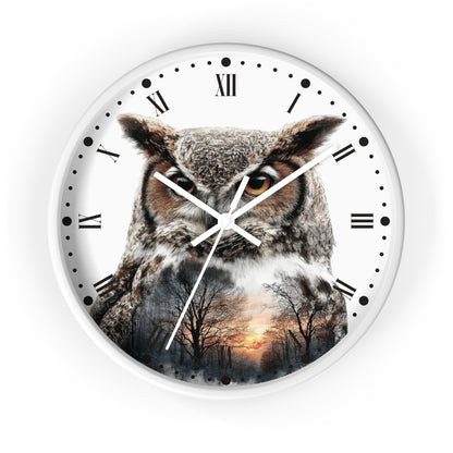A round wall clock with a white face, black Roman numerals, and white hands, featuring a large owl printed across the front with a forest sunset scene layered over its body.