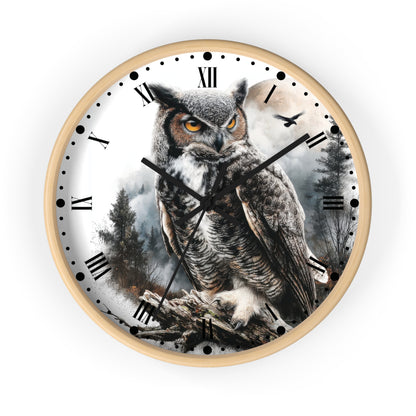 Round wall clock with a light wood frame and a printed owl scene on the face. The design shows a large brown and gray owl perched on branches against a misty forest background, with black Roman numerals and black clock hands on a white dial.
