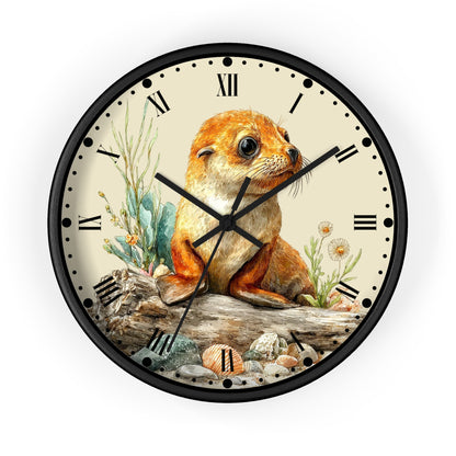 A round wall clock with a black frame and a cream-colored face, featuring a detailed illustration of a seal pup sitting on a log with plants and shells. The clock has black Roman numerals and black hands.