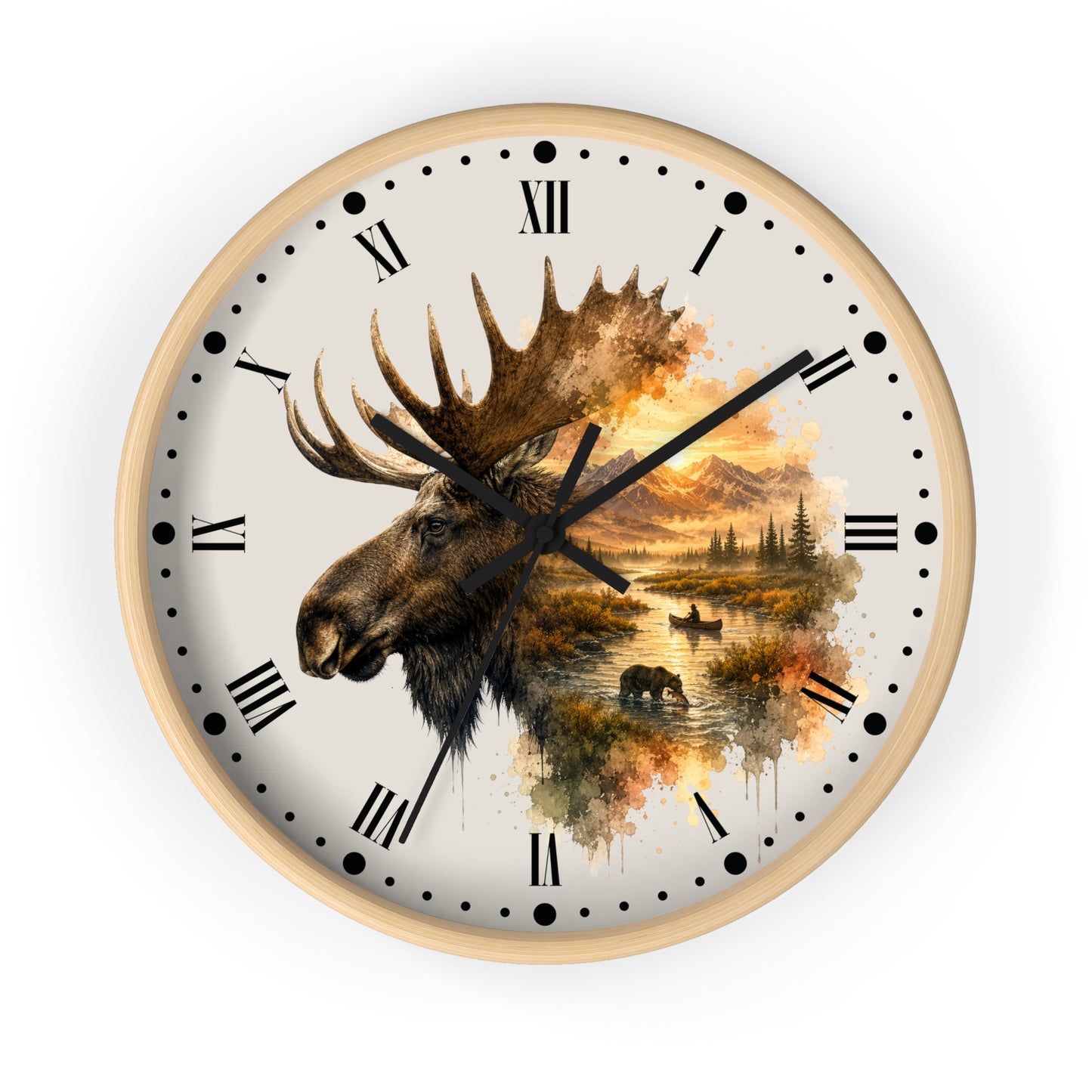 A round wall clock with a light wood frame and a cream-colored face, featuring a large moose head illustration over a scenic autumn landscape with mountains, trees, and water. The clock has black Roman numerals and black hands, shown against a plain white background.