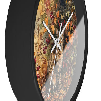 Round wall clock with a black frame and a printed autumn scene featuring a leopard, leaves, berries, and a cat, shown against a white background.