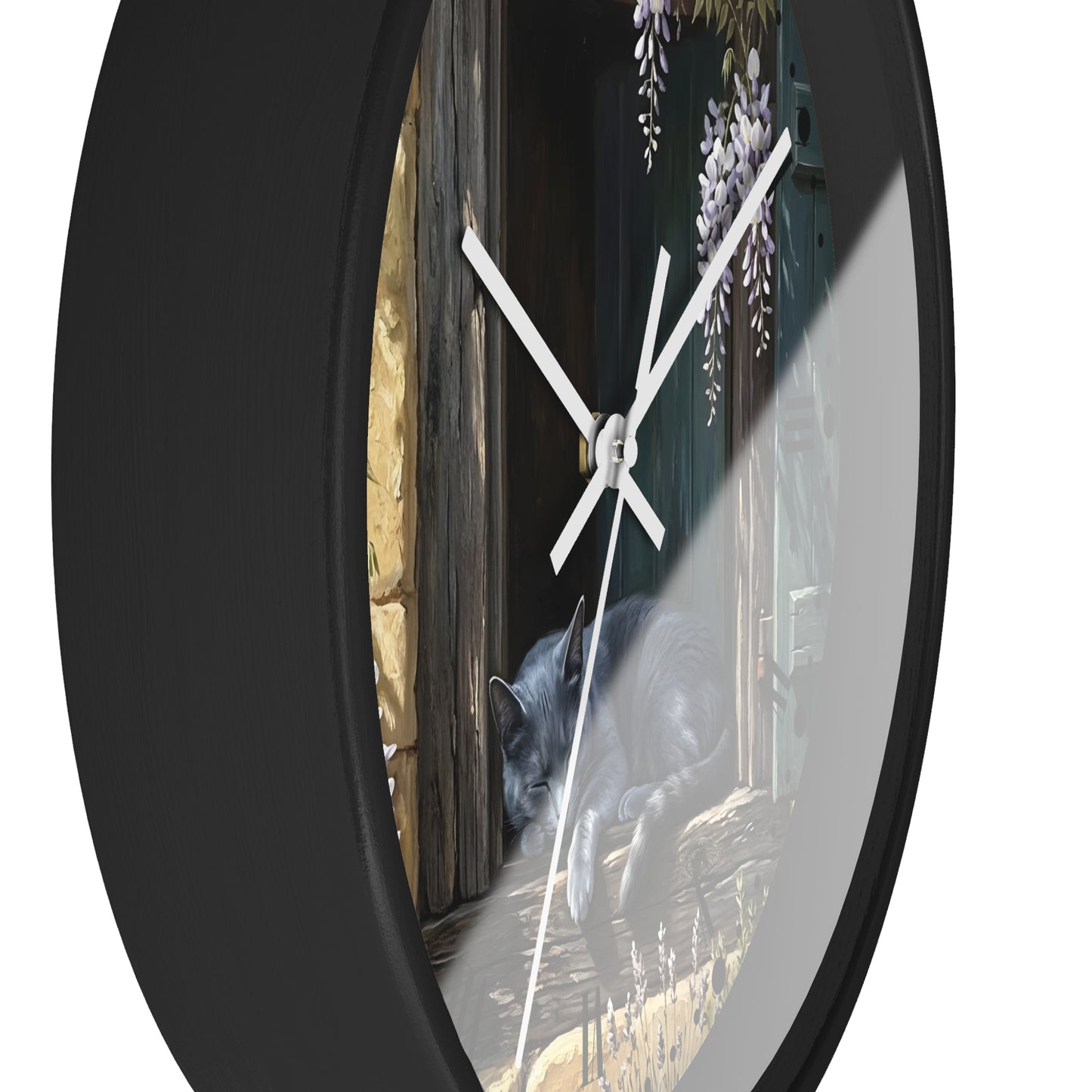 Round wall clock with a black frame and a printed scene on the face showing a black cat beside a wooden door with wisteria flowers, photographed against a white background.