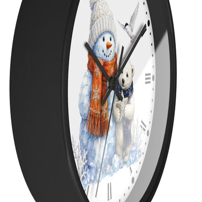 A close-up of a round wall clock with a black frame and a white face featuring a winter illustration of a snowman in an orange scarf, a polar bear, and a bird.