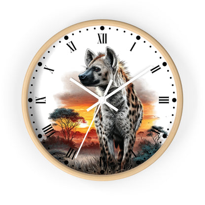 A round wall clock with a light wood frame and a printed safari design featuring a spotted hyena standing in front of an orange sunset sky with trees. The clock face is white with black Roman numerals and hands.