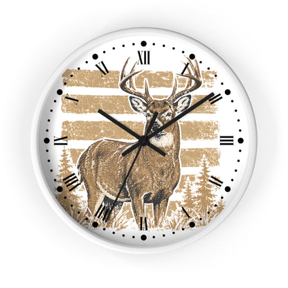 A round wall clock with a white frame and a printed deer design on the face. The clock face features a brown deer standing in front of tan horizontal stripes and pine trees, with black Roman numerals and black clock hands.